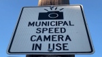 A sign alerts motorists a speed enforcement camera is in use on a road. (CTV News)