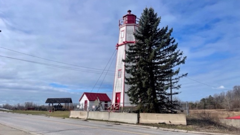 The lighthouse in Port Burwell, Ont., as seen on March 18, 2024, is blocked off and supported by cables after a report in 2023 found it in danger of toppling. The lighthouse was built in 1840. (Sean Irvine/CTV News London)