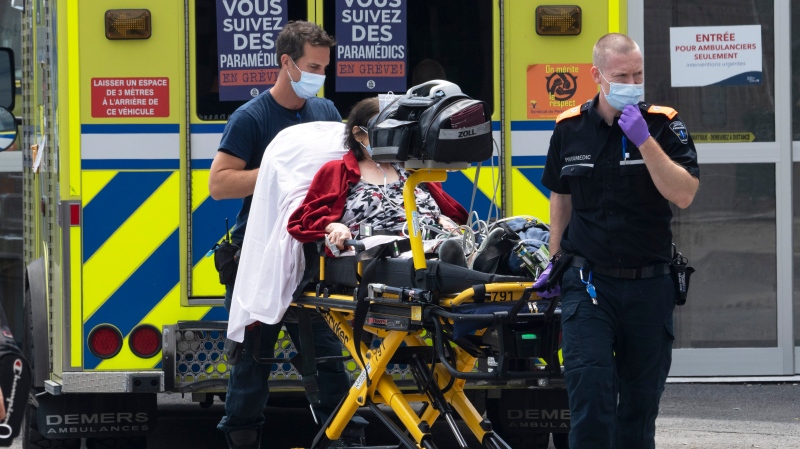 Paramedics transport a patient to the emergency room Wednesday, July 20, 2022 in Montreal. COVID-19 hospitalizations have topped 2,000 in Quebec as the seventh wave continues. (Ryan Remiorz, The Canadian Press)