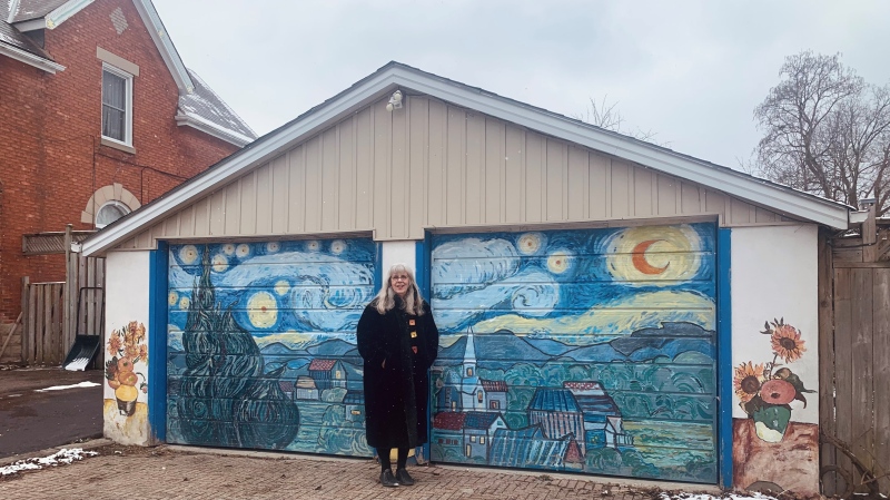London artist Brenda Fuhrman stands in front of  'The Starry Night' mural she painted on her garage in east London, Ont. on March 18, 2024. (Reta Ismail/CTV News London)  