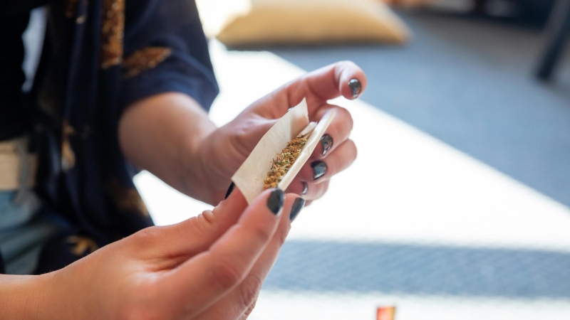 A person rolls cannabis into a joint. (Pexels)