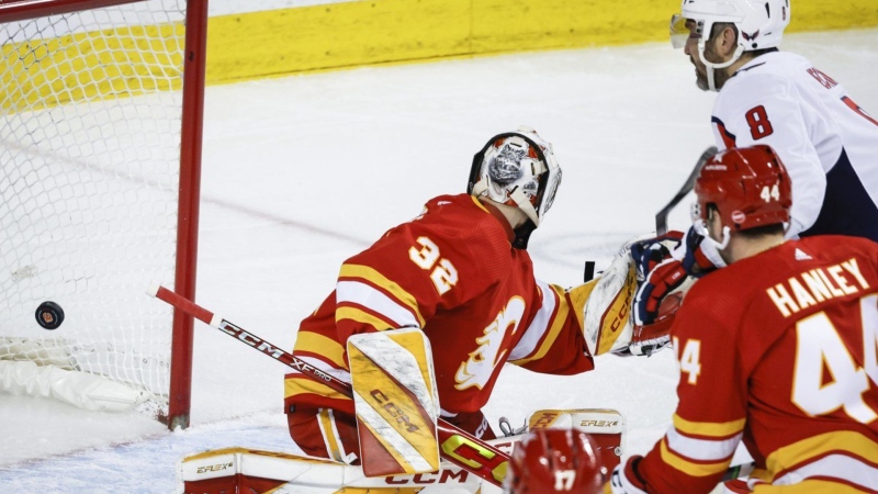 Washington Capitals forward Alex Ovechkin scores on Calgary Flames goalie Dustin Wolf in Calgary on March 18, 2024. THE CANADIAN PRESS/Jeff McIntosh