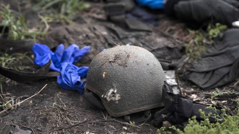 A damaged helmet is seen on the ground in an area near the border with Russia, in Kharkiv region, Ukraine, Monday, Sept. 19, 2022. (AP Photo/Leo Correa)