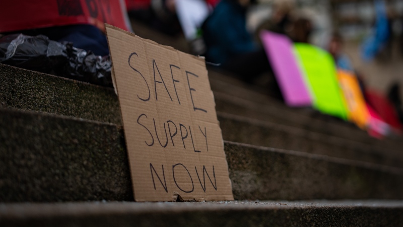 A sign reading “Safe Supply Now” is seen at a gathering outside the Provincial Court of British Columbia to support the Drug User Liberation Front in Vancouver, B.C., Tuesday, Jan. 16, 2024. THE CANADIAN PRESS/Ethan Cairns