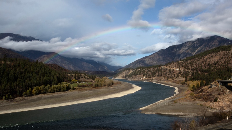 A rainbow can been seen over where the Fraser and Thompson Rivers meet in Lytton, B.C., Wednesday, Oct. 18, 2023. (Marissa Tiel / The Canadian Press)