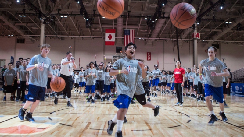 School children go through a skills drill at a Jr. NBA Day event in Toronto on Friday, February 12, 2016. THE CANADIAN PRESS/Chris Young