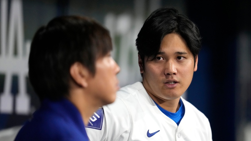 Los Angeles Dodgers' designated hitter Shohei Ohtani, right, chats with his interpreter Ippei Mizuhara during an exhibition baseball game between Team Korea and the Los Angeles Dodgers at the Gocheok Sky Dome in Seoul, South Korea, Monday, March 18, 2024. (AP Photo/Lee Jin-man)