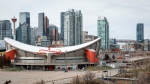 The Scotiabank Saddledome is shown with Calgary's downtown area in the background on Tuesday, April 25, 2023. (THE CANADIAN PRESS/Jeff McIntosh)