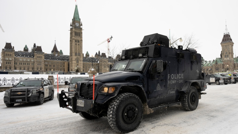An RCMP tactical vehicle drives past the Parliament buildings, Sunday, Feb. 20, 2022 in Ottawa. (THE CANADIAN PRESS/Adrian Wyld)