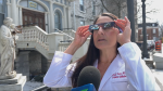 Dr. Yi Ning Strube, a pediatric ophthalmologist with the Kingston Health Sciences Centre, explains the proper way to use eclipse glasses. (Jack Richardson/CTV News Ottawa)