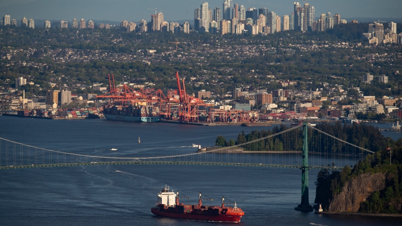 The container ship Ballenita passes under the Lions Gate Bridge after leaving port, in Vancouver, B.C., Monday, May 18, 2020. (Darryl Dyck / The Canadian Press)