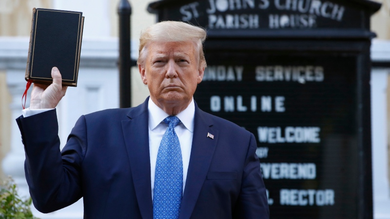 Former U.S. President Donald Trump holds a Bible as he visits outside St. John's Church across Lafayette Park from the White House, June 1, 2020, in Washington. (AP Photo / Patrick Semansky, File)