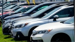 Used cars for sale are parked roadside at an auto lot in Philadelphia, Tuesday, July 12, 2022. (AP Photo/Matt Rourke)