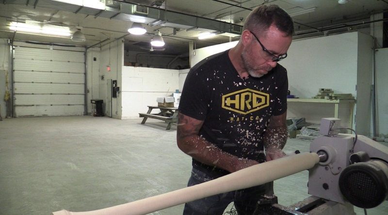 Trevor Oakes, owner of HRD Bat Company, carves a custom bat at his shop in Caledonia, Ont. on March 25, 2024. (Brent Lale/CTV News London)