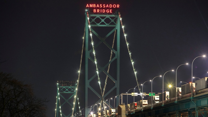 Trucks are lined up on the Ambassador Bridge which spans the Detroit River between Windsor and Detroit, Michigan, is shown from Windsor, Ont., on Saturday, December 18, 2021. 