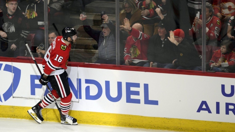 The Chicago Blackhawks' Jason Dickinson celebrates with fans after scoring against the Calgary Flames in Chicago on March 26, 2024. (AP Photo/Paul Beaty)
