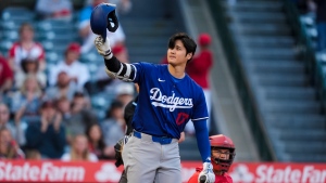 Los Angeles Dodgers designated hitter Shohei Ohtani gestures to the crowd before batting against the Los Angeles Angels during the first inning of an exhibition baseball game Tuesday, March 26, 2024, in Anaheim, Calif. (AP Photo/Ryan Sun) 