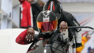 Cynthia Appiah, bottom, and Morgan Ramsey, of Canada, start their first run in the two-woman bobsled World Cup competition in Lake Placid, N.Y., Saturday, March 23, 2024. (AP Photo/Seth Wenig)