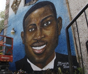 In this May 17, 2020, file photo, a recently painted mural of Ahmaud Arbery is on display in Brunswick, Ga., where the 25-year-old man was shot and killed in February. (AP Photo/Sarah Blake Morgan, File)