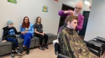 A hairstylist giving a haircut to a child with autism for Autism Awareness Month on March 27, 2024. (Matt Marshall/CTV News Edmonton)