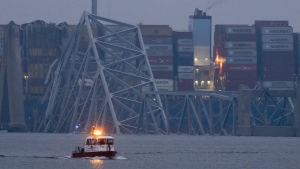  Recovery efforts resumed Wednesday for the construction workers who are presumed dead after the cargo ship hit a pillar of the bridge, causing the structure to collapse. (Matt Rourke/AP Photo)