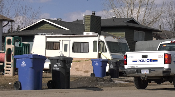 A police cruiser patrols outside of a home near Matthews Park in Fort St. John. 