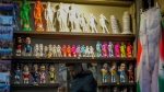 A vendor sells souvenirs of Michelangelo's 16th-century statue of David at a kiosk in downtown Florence, Italy, Monday, March 18, 2024. (AP Photo/Andrew Medichini)