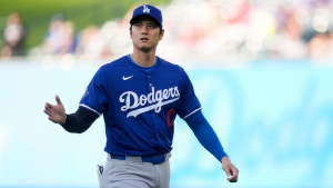 Los Angeles Dodgers designated hitter Shohei Ohtani warms up before an exhibition baseball game against the Los Angeles Angels, Tuesday, March 26, 2024, in Anaheim, Calif. (Ryan Sun / AP Photo)