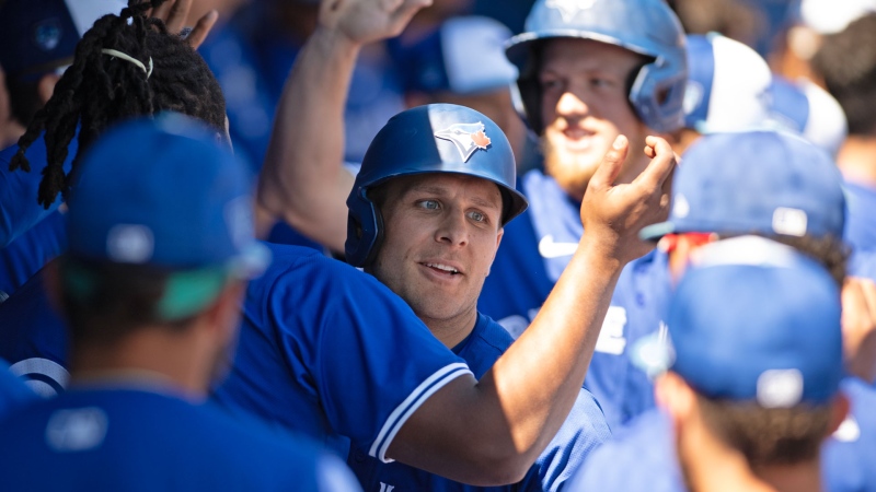 Toronto Blue Jays outfielder Daulton Varsho is congratulated by teammates after hitting a home run during spring training action against the Baltimore Orioles Tuesday, March 19, 2024, in Dunedin, Florida. THE CANADIAN PRESS/Mark Taylor