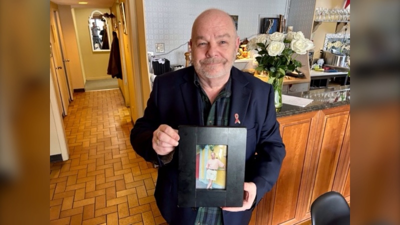 Bryan Lavery holds a picture of his late brother, Gary, who died of AIDS in 2004. Lavery is now a chef at a London, Ont. restaurant supporting A Taste for Life fundraiser for Regional HIV/AIDS. It takes place at 15 London restaurants on April 17th. (Sean Irvine/CTV News London) 