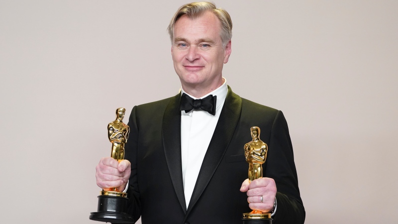 Christopher Nolan poses in the press room with the awards for best director and best picture for 'Oppenheimer' at the Oscars on Sunday, March 10, 2024, at the Dolby Theatre in Los Angeles. (Photo by Jordan Strauss / Invision / AP)