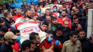 People carry the coffins of paramedics who were killed in an Israeli airstrike, during a funeral procession in Hebbariye village, south Lebanon, Wednesday, March 27, 2024. (AP Photo / Mohammed Zaatari)