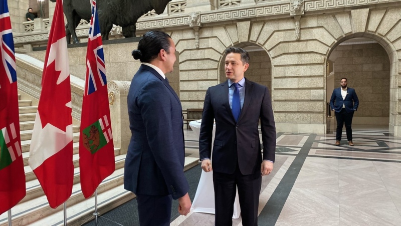 Wab Kinew and Pierre Poilievre meet at the bottom of the rotunda at the Manitoba legislature on March 28, 2024. (Taylor Brock/CTV News Winnipeg)