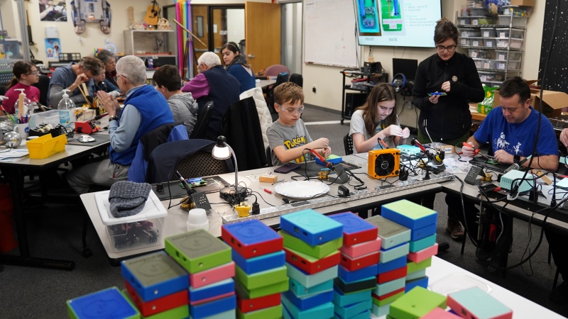 Workshop participants assemble LightSound devices at the New England Sci-Tech education center in Natick, Mass., on March 2, 2024. (AP Photo/Mary Conlon)