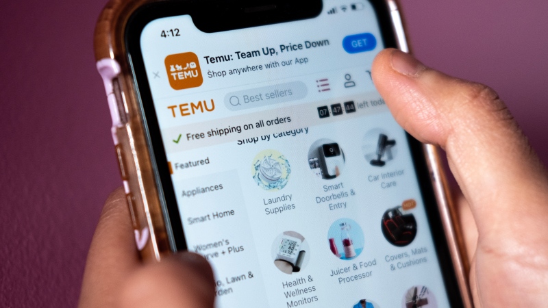 A person navigates the Temu website on a smartphone in Toronto, Tuesday, April 4, 2023. Temu launched in Canada in early February -- the same month it aired a Super Bowl ad with the tagline 'shop like a billionaire' -- offering consumers an alternative to online juggernaut Amazon. (Giordano Ciampini, The Canadian Press)