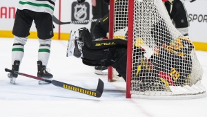 Vancouver Canucks goalie Casey DeSmith falls into the net and loses his stick after Dallas Stars' Wyatt Johnston collided with him and was given a goalie interference penalty on Thursday, March 28, 2024. (THE CANADIAN PRESS/Darryl Dyck)