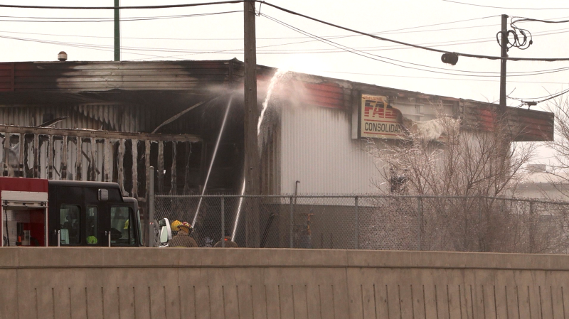 Crews battled a blaze that spread from a trailer to a building at a trucking terminal in Winnipeg's Weston Shops neighbourhood on March 29, 2024. (Glenn Pismenny/CTV News)