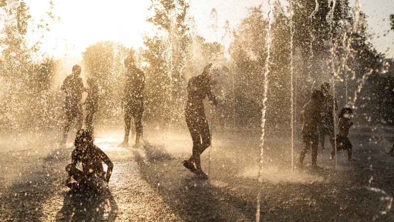 Children play with water at a fountain during a heatwave, at Stavros Niarchos foundation Cultural Center in Athens, July 21, 2023. (AP Photo/Petros Giannakouris, File) 