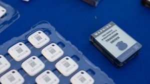 Mobile tracking devices and stickers from the Metropolitan Police Department are seen on a table in Washington on Tuesday, Nov. 7, 2023. Police in Burlington, Vt. say its residents are finding hidden AirTags and other GPS tracking devices on vehicles returning from Montreal. THE CANADIAN PRESS/AP-Amanda Andrade-Rhoades