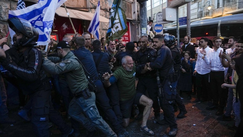 Police push away members of Brothers and Sisters in Arms during a protest in Jerusalem on March 31, 2024. (Ohad Zwigenberg/AP Photo)