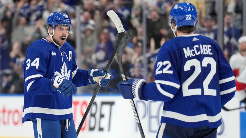 Toronto Maple Leafs centre Auston Matthews (34) celebrates his last minute empty net goal against the Florida Panthers with teammate defenceman Jake McCabe (22) during third period NHL hockey action in Toronto on Monday, April 1, 2024. THE CANADIAN PRESS/Frank Gunn 