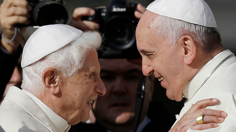 Pope Francis, right, hugs Emeritus Pope Benedict XVI prior to the start of a meeting with elderly faithful in St. Peter's Square at the Vatican on Sept. 28, 2014. (AP Photo/Gregorio Borgia, File)