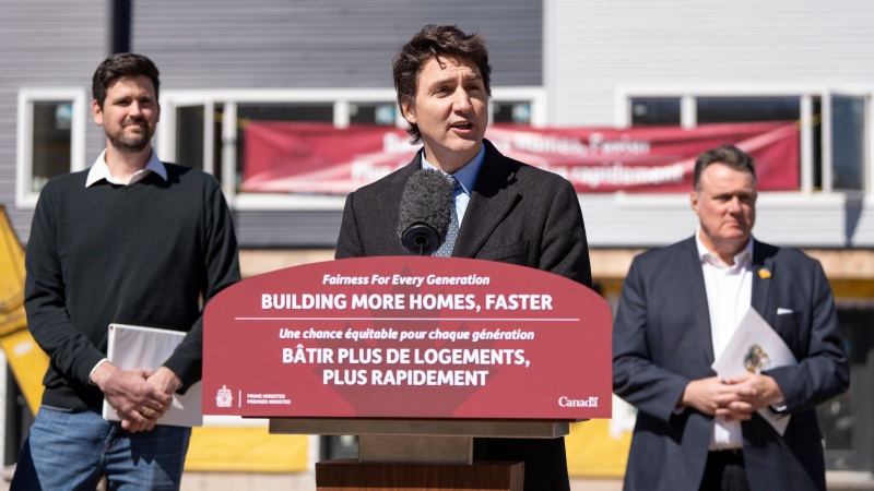 Prime Minister Justin Trudeau, centre, is flanked by Minister of Housing, Infrastructure and Communities Sean Fraser, left, and mayor of Halifax Mike Savage while making a housing announcement in Dartmouth, N.S. on Tuesday, April 2, 2024. THE CANADIAN PRESS/Darren Calabrese