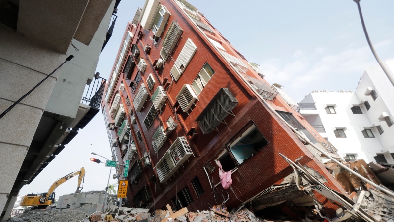 Debris surrounds a titled building a day after a powerful earthquake struck in Hualien City, eastern Taiwan, Thursday, April 4, 2024. (AP Photo/Chiang Ying-ying)