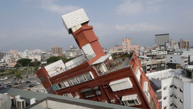 A partially collapsed building stands at a titled angle a day after a powerful earthquake struck in Hualien City, eastern Taiwan, Thursday, April 4, 2024. (AP Photo/Chiang Ying-ying)