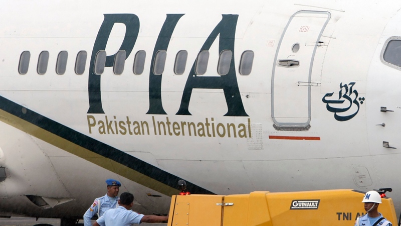 A Pakistan International Airlines passenger jet is parked at a military base in Makassar, Indonesia on March 7, 2011. (AP Photo) 