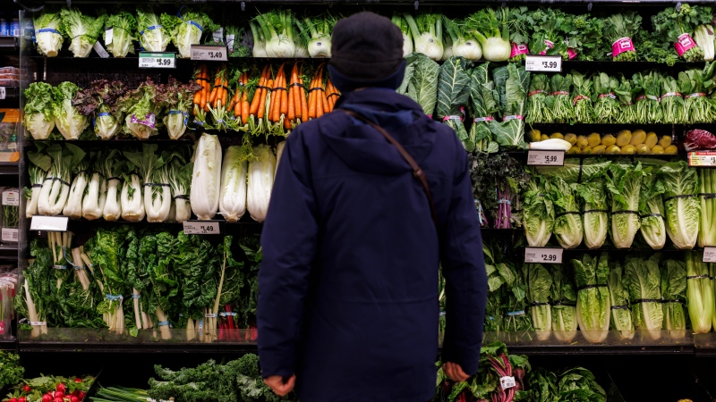 A customer shops in the produce section at a Metro grocery store In Toronto on Friday, Feb. 2, 2024. (Cole Burston / The Canadian Press)