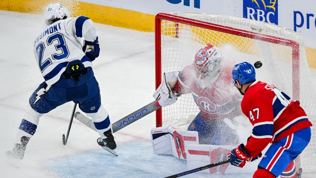 Tampa Bay Lightning's Michael Eyssimont (23) scores against Montreal Canadiens goaltender Cayden Primeau as Canadiens' Jayden Struble (47) defends during first period NHL hockey action in Montreal, Thursday, April 4, 2024. (THE CANADIAN PRESS/Graham Hughes)