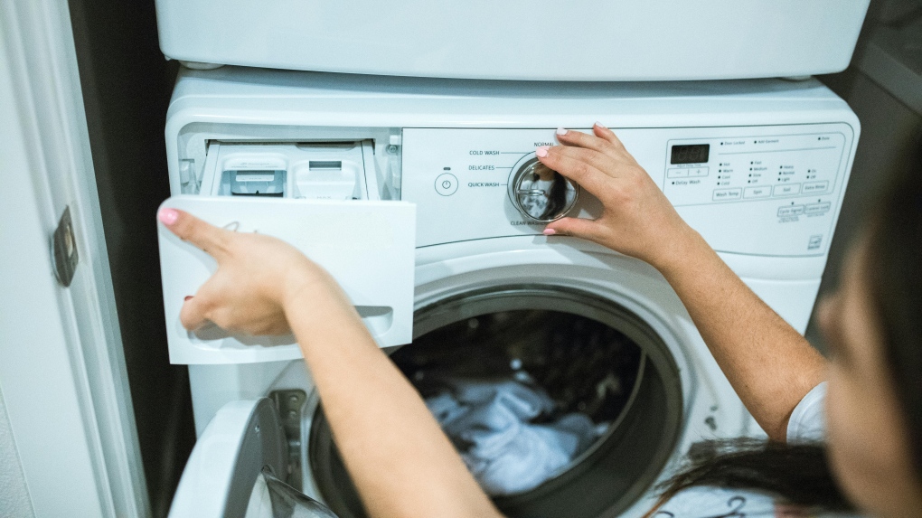 A person using a laundry machine
