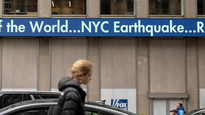 A display shows the news about an earthquake in New York City at News Corp Headquarters, Friday, April 5, 2024, in New York.  (AP Photo/Yuki Iwamura)